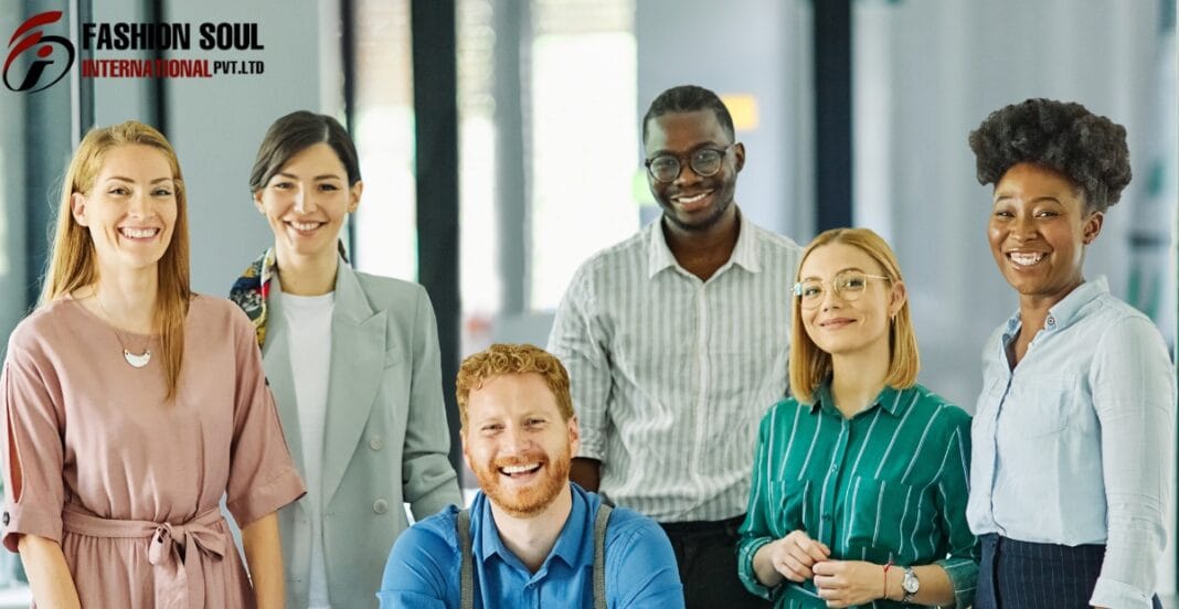 A diverse group of seven smiling professionals standing together in an office, with the logo 