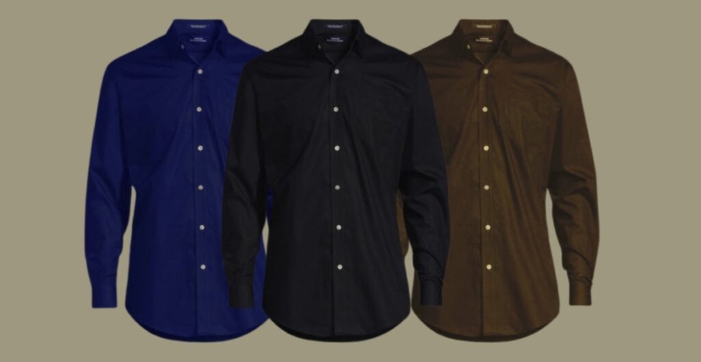 A row of premium men’s cotton work shirts in white, light blue, and navy hanging neatly on a rack, highlighting soft fabric and well-constructed stitching.