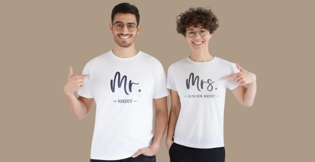A diverse group of office staff wearing eco-friendly organization T-shirts in a bright, modern workspace. Shirts are made from sustainable materials with subtle earth-toned colors, visible recycling and organic cotton labels, and a minimalist logo. The team is collaborating at a whiteboard and sorting recyclable materials, underscoring sustainability, style, and practicality.