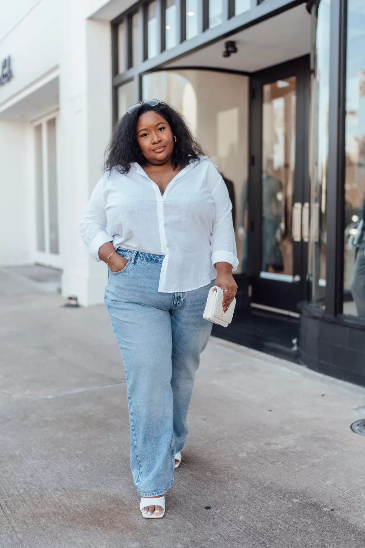 Plus-size woman in denim button-up shirt styled casually for a relaxed weekend look
