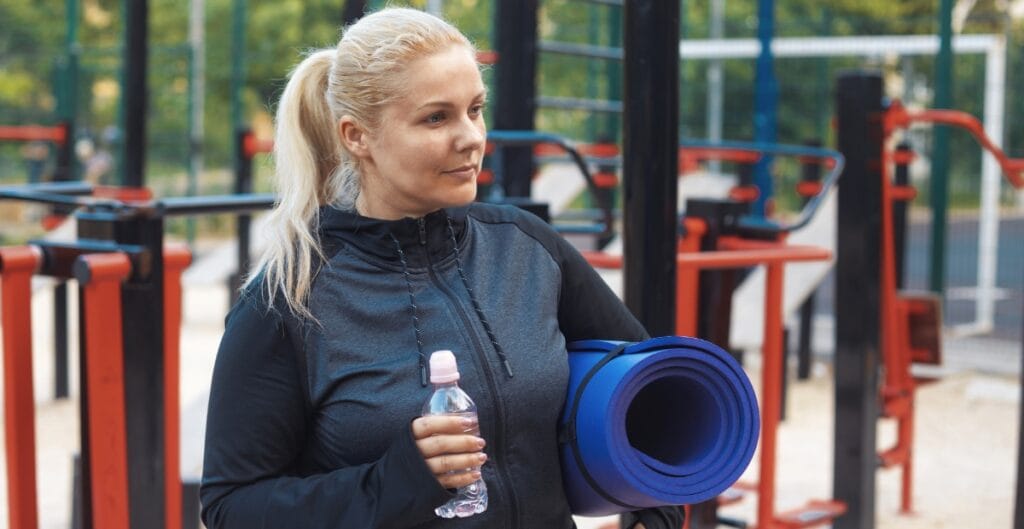 Close-up of a plus-size workout jacket being washed by hand or laid flat for air drying, emphasizing care labels and gentle handling.