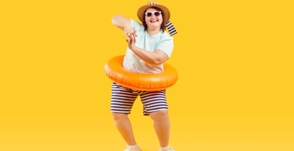 Happy woman in plus size lycra shorts and striped shirt with an inflatable ring, enjoying a fun moment