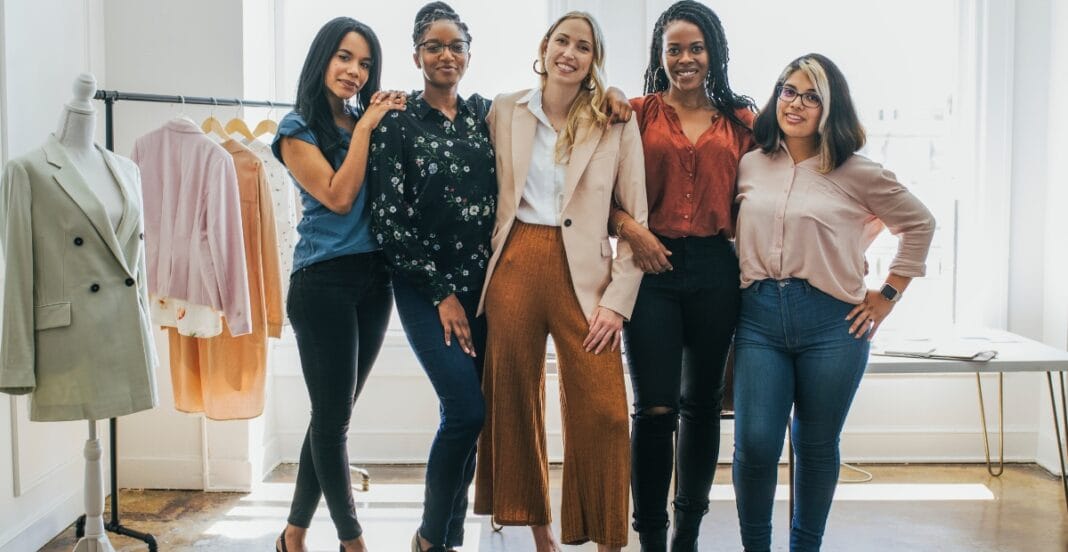 A group of women showcasing trendy clothes for short-waisted women, including high-waisted pants and tailored blazers