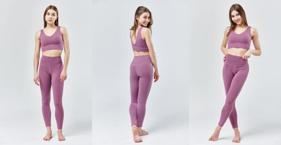A woman posing in a full-body shot wearing purple gym leggings for ladies, showcasing the leggings' fit and design
