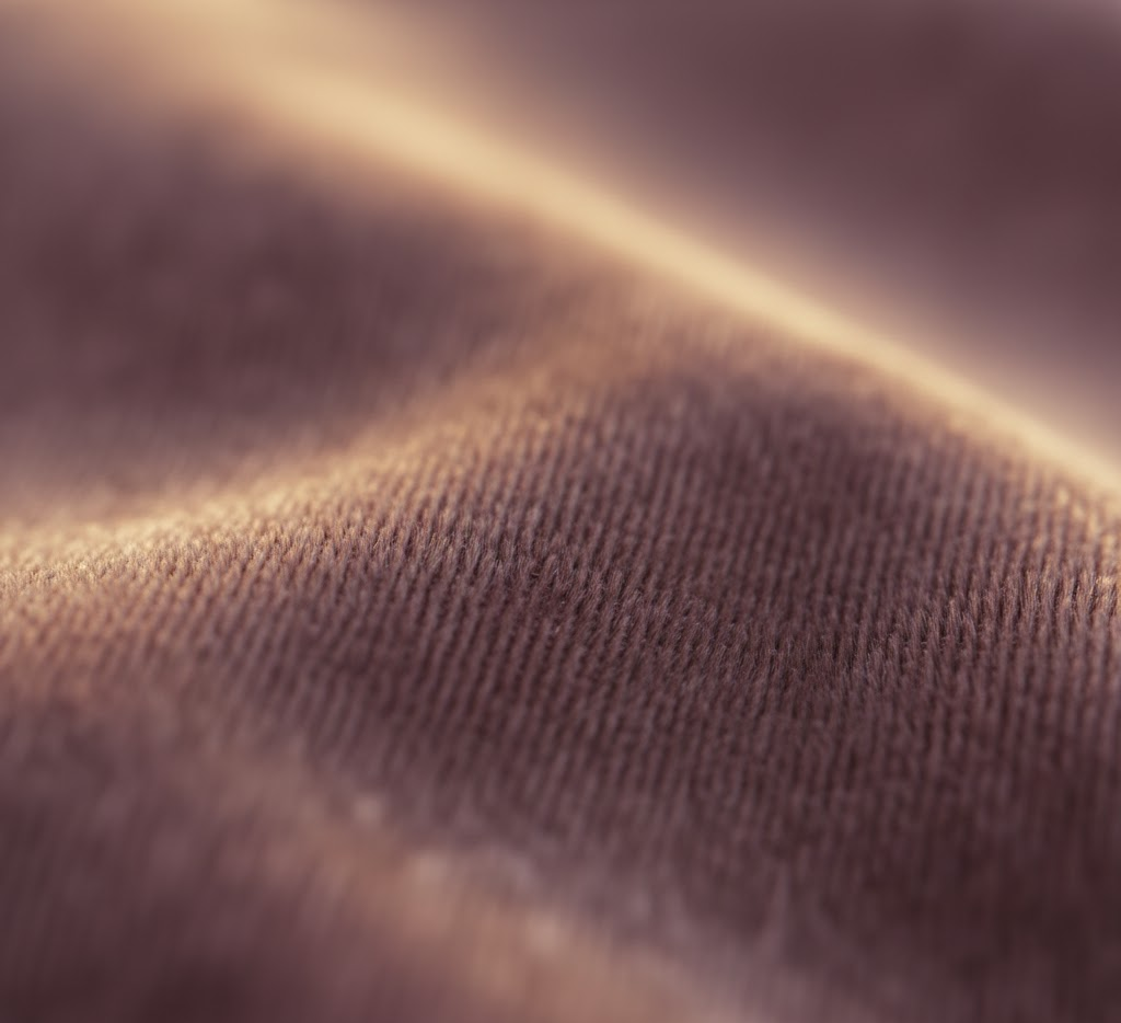 Close-up of mauve velvet fabric showing rich sheen
