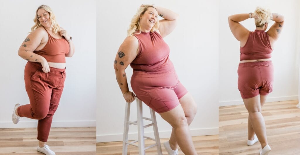 Smiling plus size woman in rust-colored sweat suits posing confidently in a bright studio.