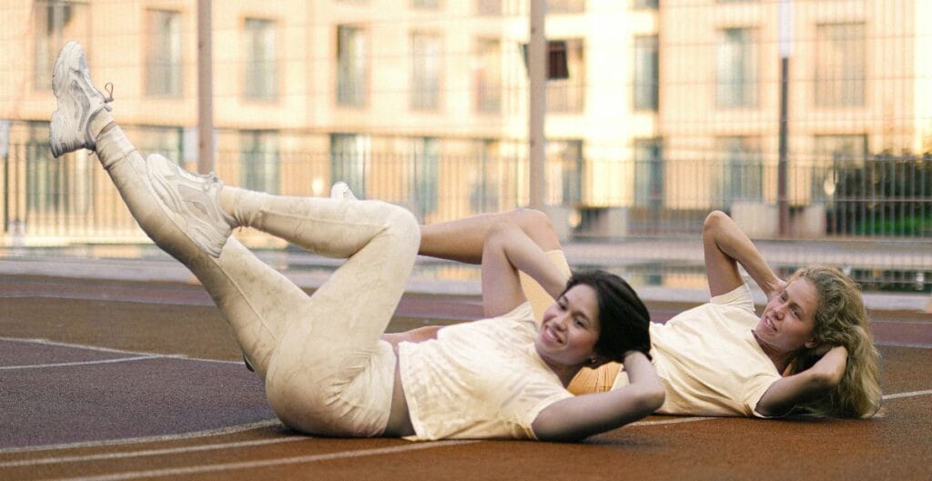 Two women performing exercises in ladies seamless leggings, showcasing flexibility and style