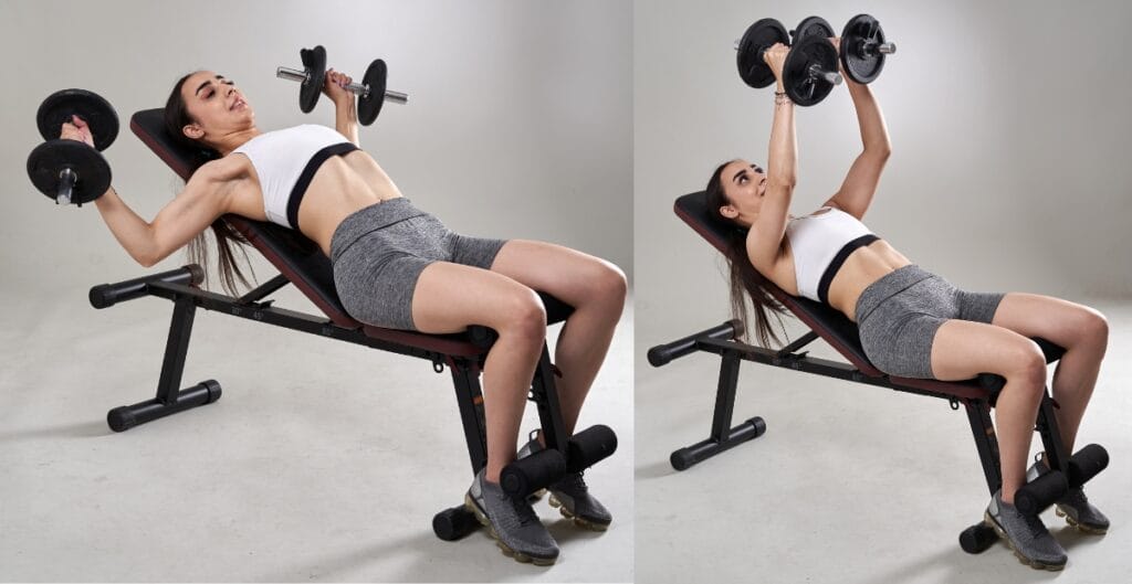 Woman lifting dumbbells in workout bottoms during an incline bench press exercise
