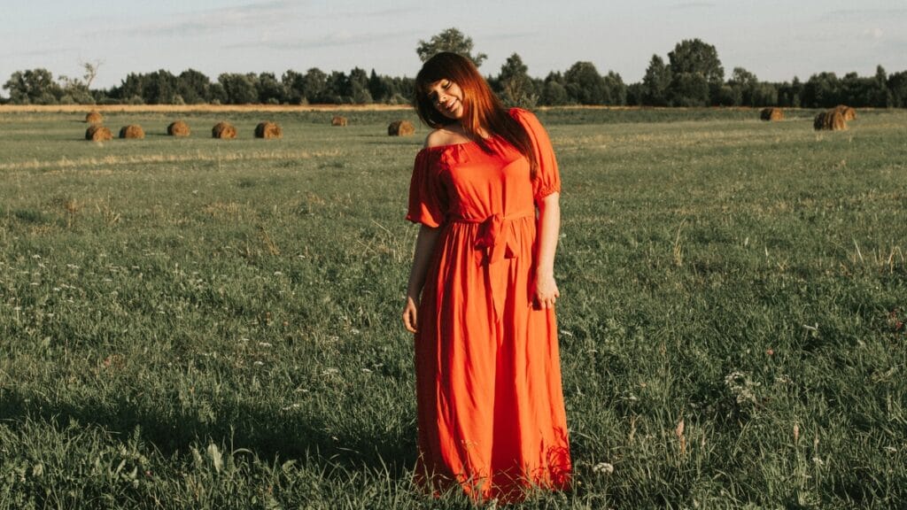 plus maxi dress in a flowy style worn outdoors in a natural green field