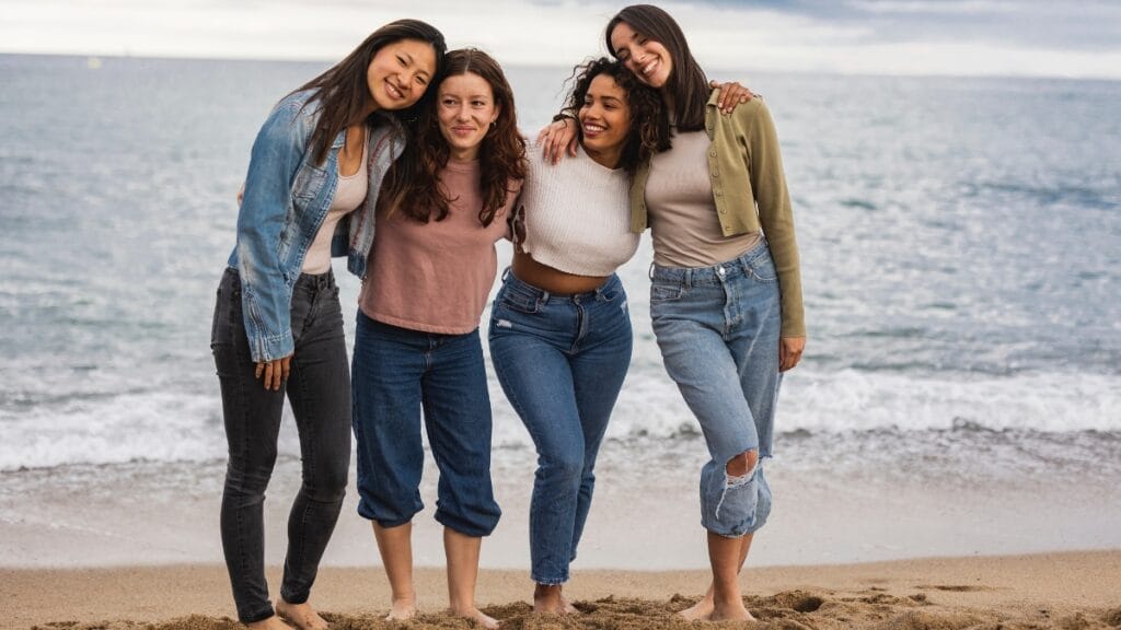 Curvy tweens posing on the beach in relaxed casual outfits, enjoying a sunny day together.