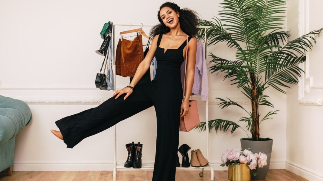 Effortlessly Elegant: Dressy Pants for Every Occasion A confident woman poses in a black jumpsuit, paired with dressy pants, offering a trendy yet professional style perfect for any occasion