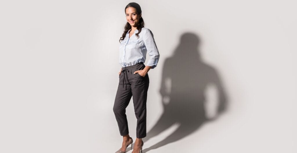 Woman dressed in a blue shirt paired with a casual pant dress, giving off a confident yet relaxed vibe.