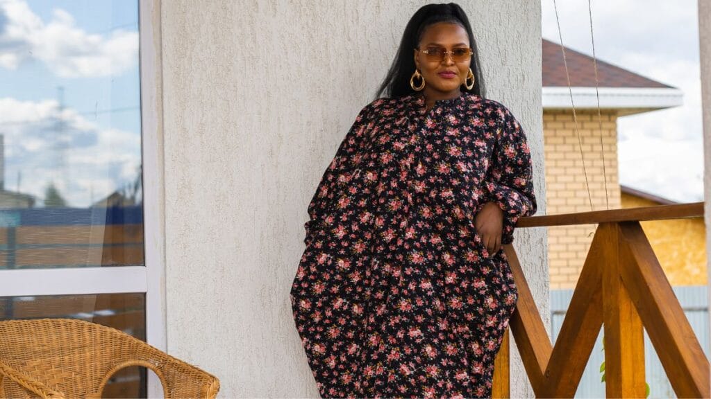 plus floral dress in a dark floral print worn outdoors on a terrace with a natural relaxed pose
