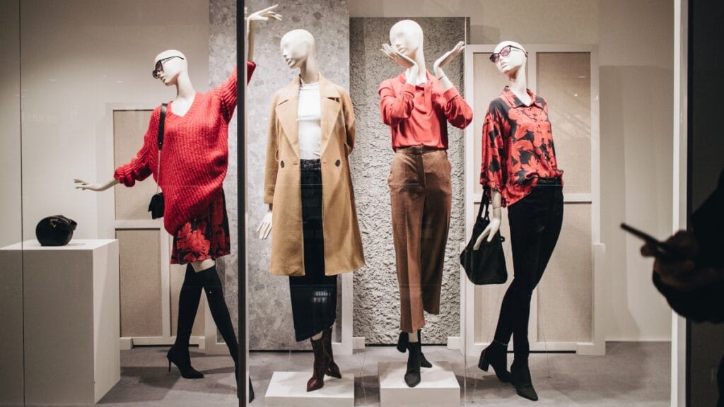 Models showcasing trendy sexy midi dresses in a store display