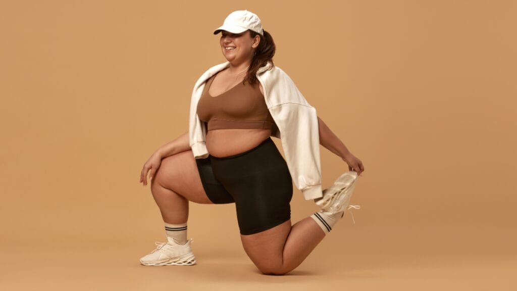 Plus-size woman stretching in athletic shorts, showcasing activewear options