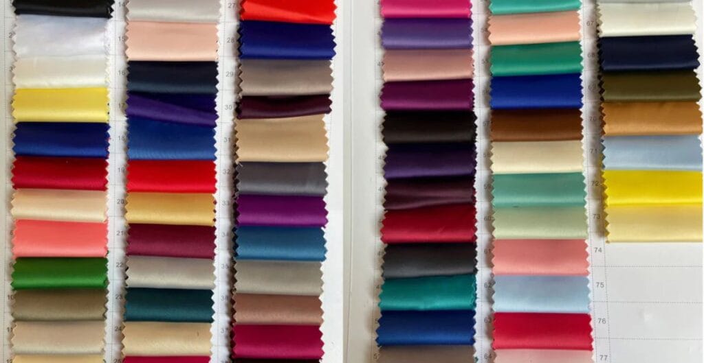 Minimalist winter look: monochrome outfit with a thick turtleneck, cropped leather jacket, and knee-high boots, amid snow-covered streets.
