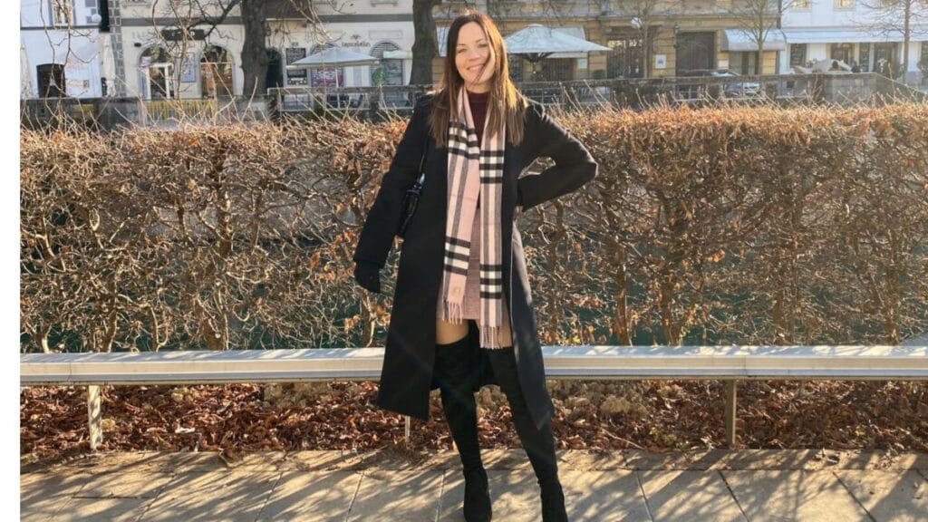 A group of five women standing together outdoors, dressed in stylish winter outfits. Each woman is wearing a different fashionable coat, with accessories like sunglasses, scarves, and bags. They are smiling and posing in front of a colorful backdrop, showcasing their winter fashion looks.
