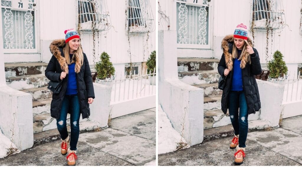 A woman in a black hooded winter coat, blue sweater, and red sneakers, walking outdoors in a snowy setting.