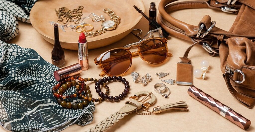 A bold winter outfit: metallic-finish puffer jacket, wide-leg pants, and structured gloves, with frosted streetlights in the background.
