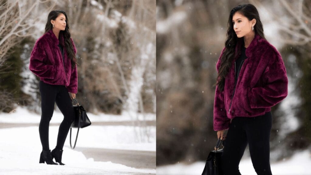 "Woman wearing a purple faux fur winter jacket and black leggings in a snowy setting."