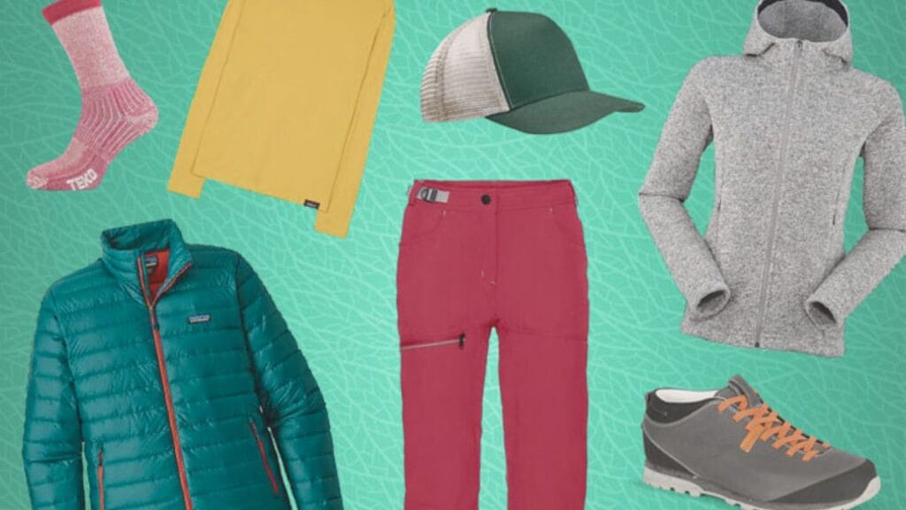 A collection of winter and outdoor clothing items arranged on a teal patterned background, including pink socks, a yellow long-sleeve shirt, a green puffer jacket, a mesh trucker cap, red outdoor pants, a gray zip-up fleece jacket, and gray hiking shoes with orange laces.