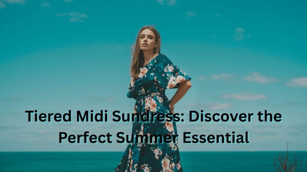Woman wearing a floral tiered midi sundress standing outdoors by the sea, showcasing a flowy summer dress ideal for warm weather.