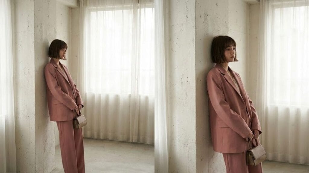 Woman wearing a modern pink core fashion outfit with clean tailoring