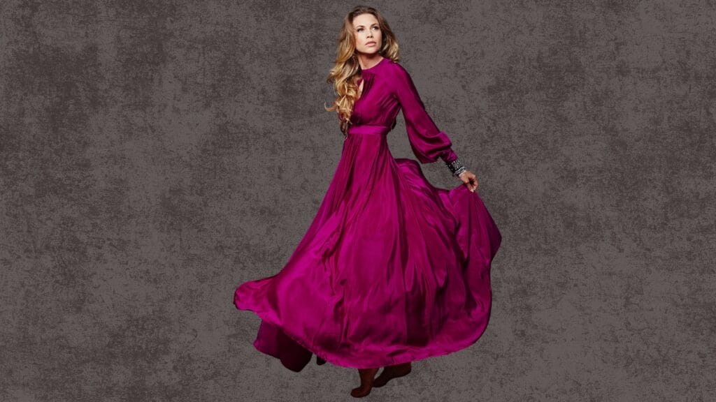 Woman in a flowing purple cocktail dress, size 14, twirling against a dark background