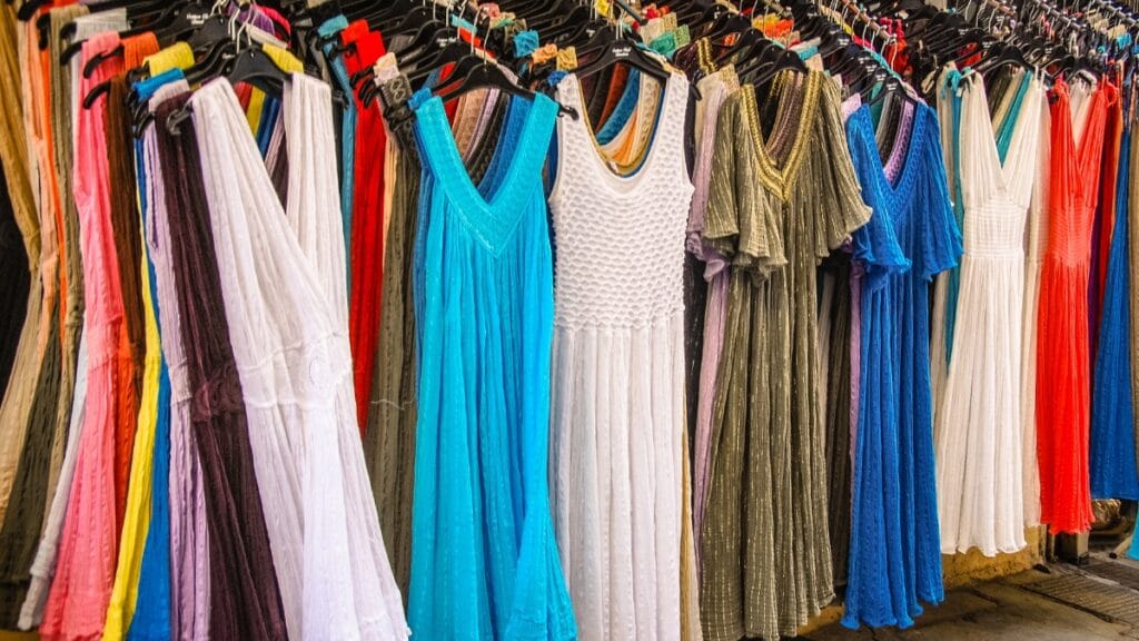 Colorful inexpensive midi dresses hanging on display in a store