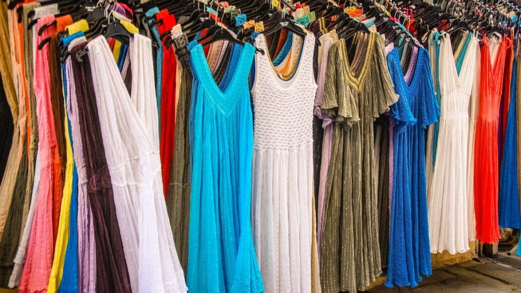 Colorful inexpensive midi dresses hanging on display in a store