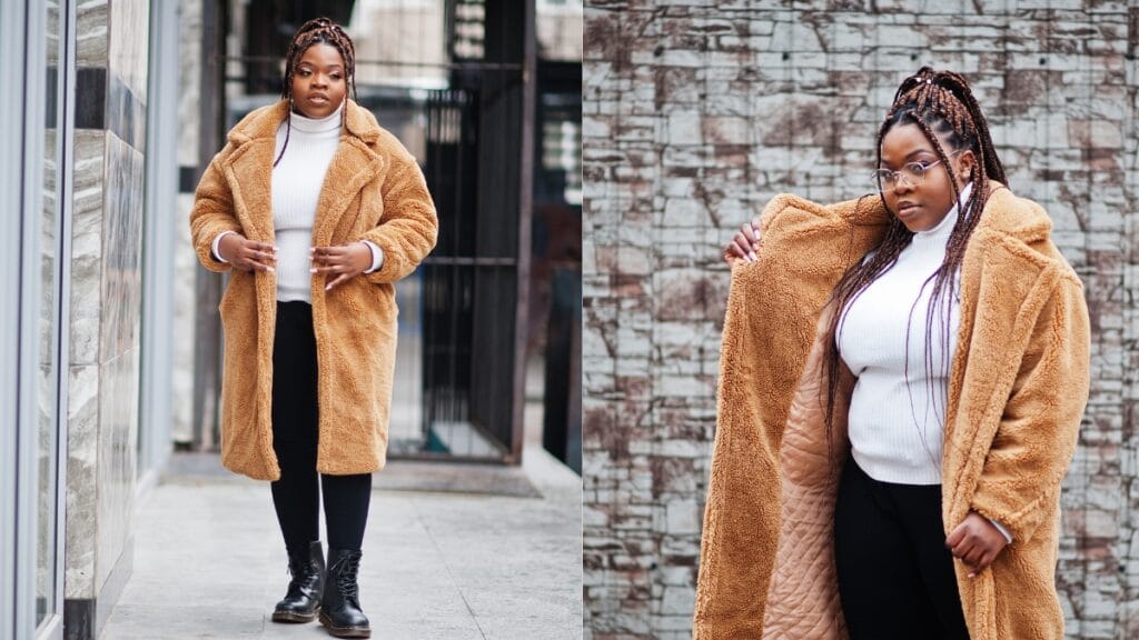 Plus size woman wearing a cozy brown winter coat with a white sweater and black boots