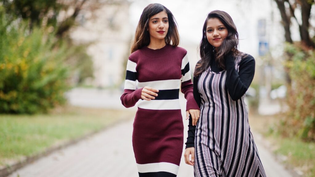 Two women walking outdoors, showcasing casual long sleeve midi dresses.