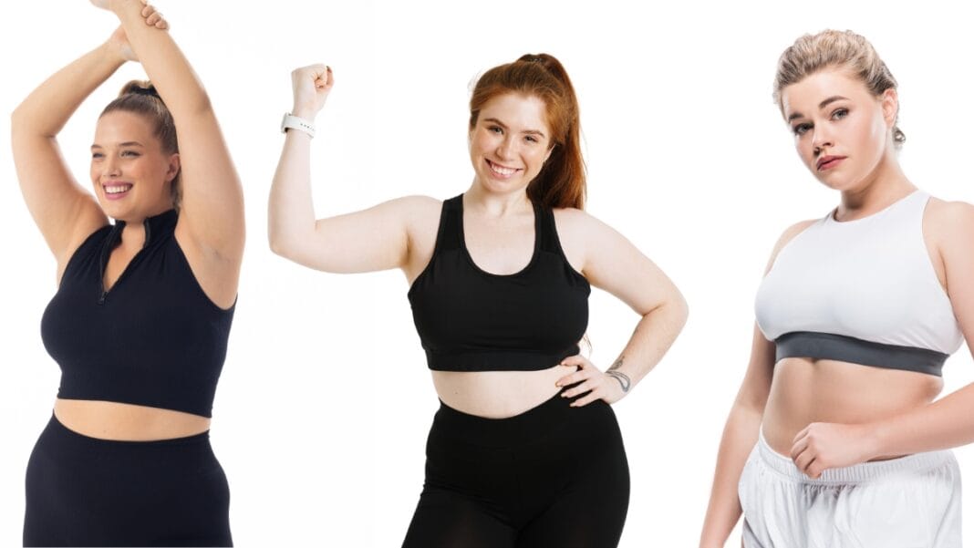 Plus size woman wearing a black sports bra and black leggings, showing strength with a confident smile.