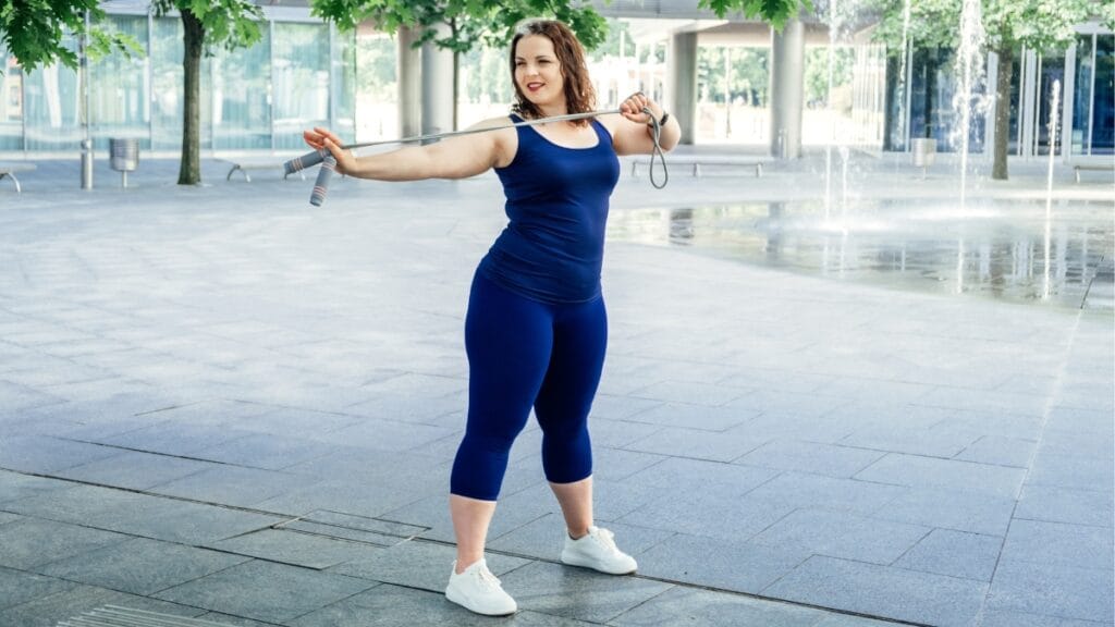 Plus size workout romper in blue, perfect for outdoor exercises like skipping