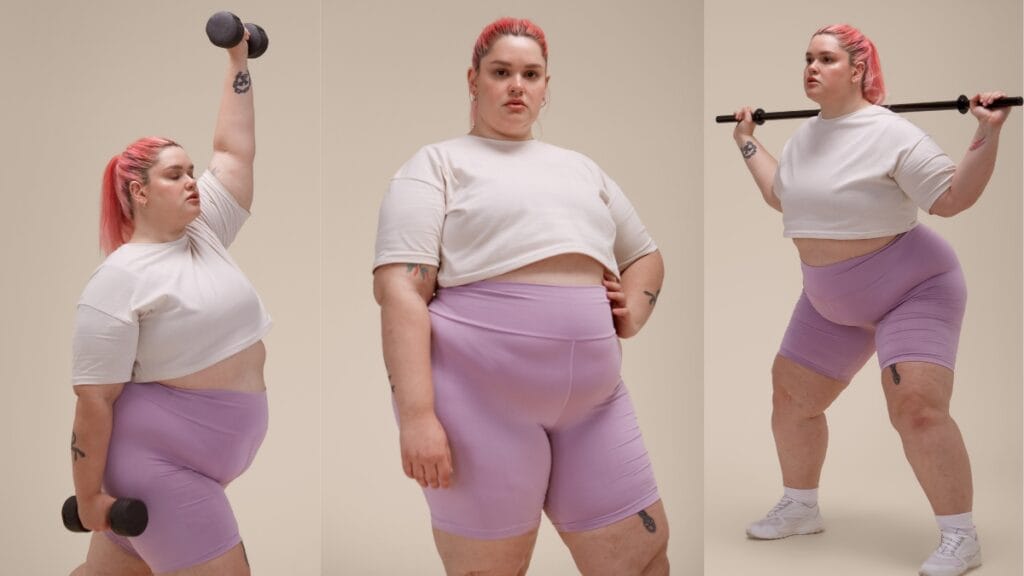 Short fat woman in purple workout gear, lifting weights and striking a confident pose