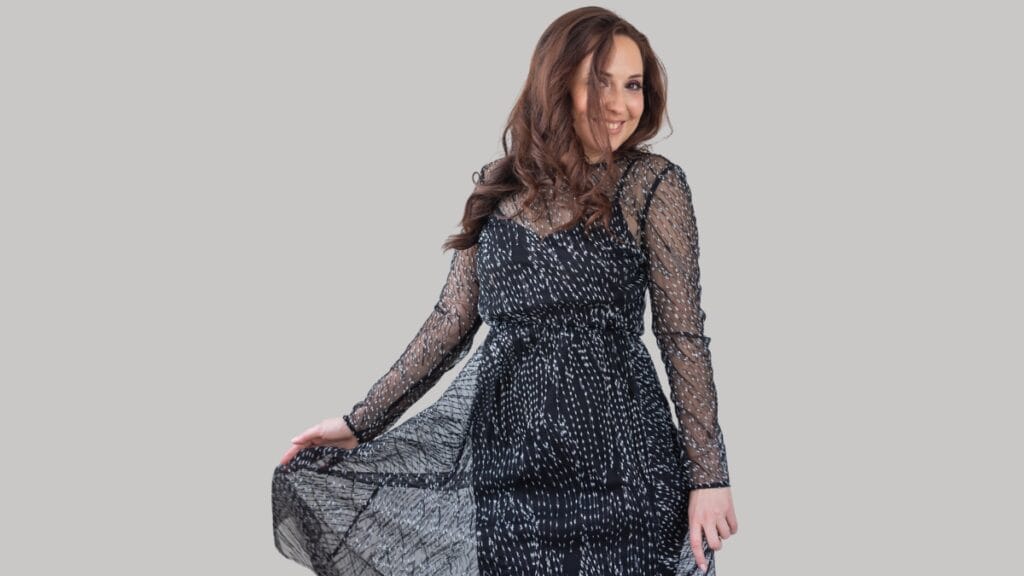 Woman in a stylish black dress, perfect for size 12 women dress shopping