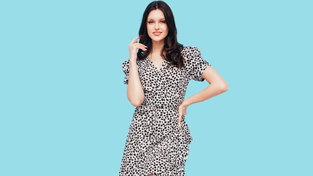 Elegant Size 12 Women's Dress with Black and White Spot Print Size 12 women's dress with a black and white spotted pattern, paired with a flattering silhouette against a bright blue background.