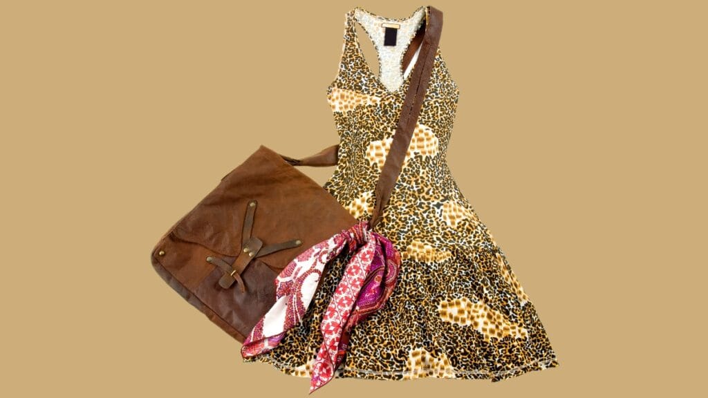 Size 12 women's dress with a leopard print pattern, paired with a brown leather handbag and a colorful scarf.