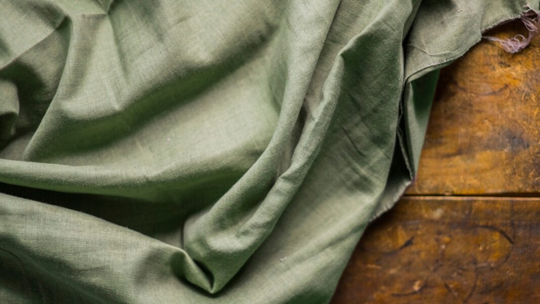 Exploring the Best Clothing Materials for Comfort and Style Close-up of a green fabric, showcasing one of the best clothing materials for comfort and style.