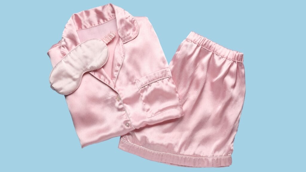 Elegant pink silk sleepwear set with a sleep mask, perfect for a luxurious night’s rest