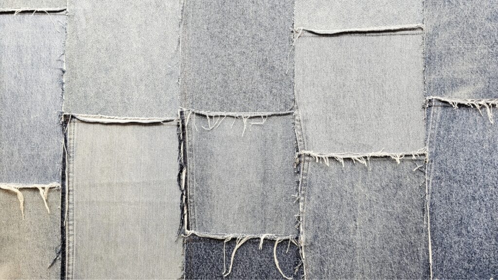 Denim vs Cotton: Close-up of denim fabric patchwork showing different shades and textures