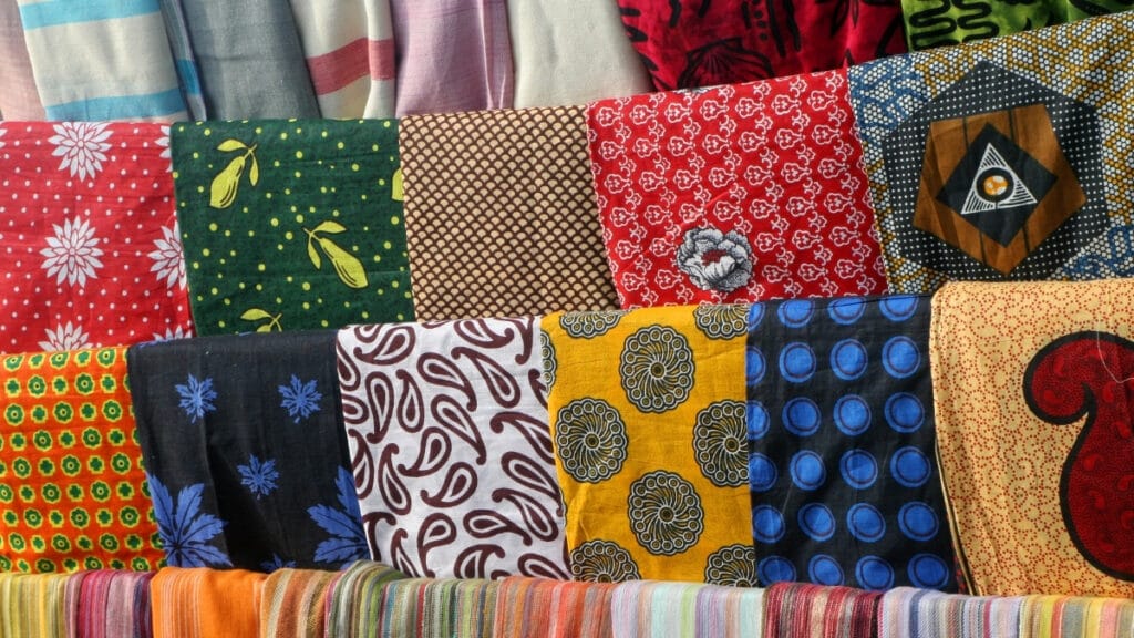 Various types of cotton materials with pictures of fabrics featuring traditional patterns and colors.