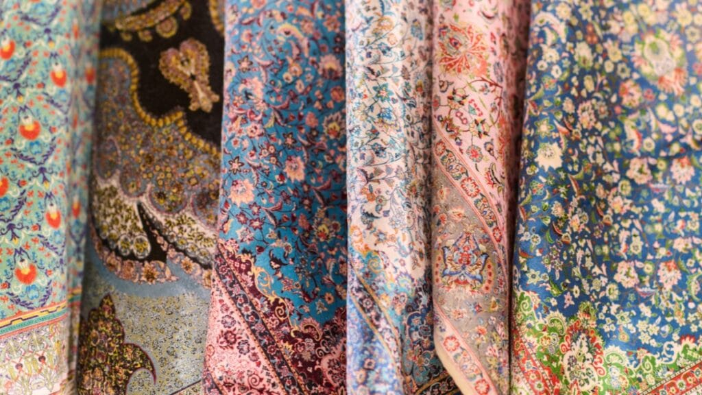 A close-up of colorful fabric prints with floral and paisley patterns