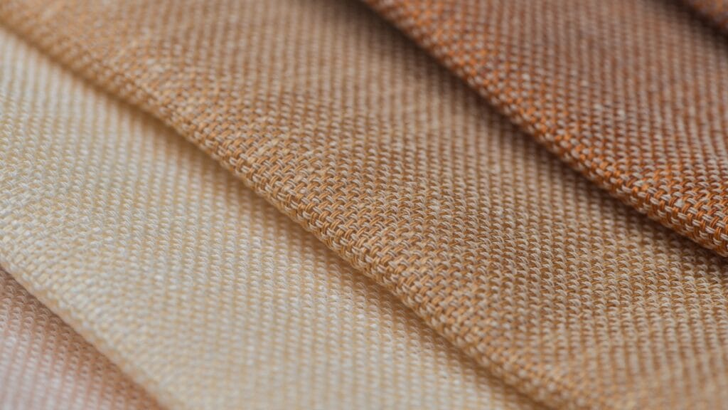 Close-up of fabrics showcasing different fabric thicknesses in beige and brown shades