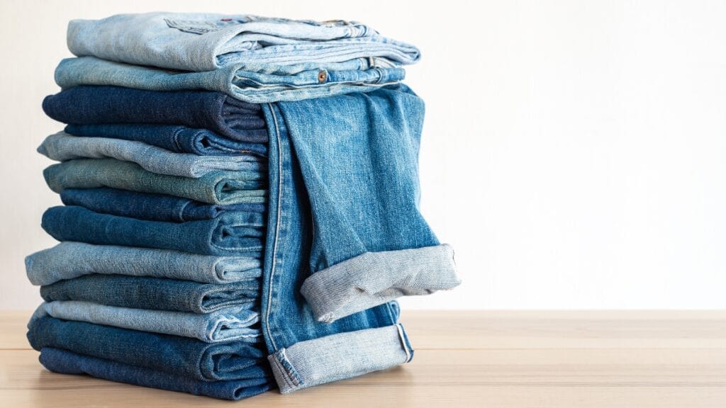 Stack of folded denim jeans ready for cleaning