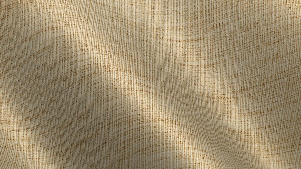 A detailed macro view of beige nylon fabric showing a tight, durable weave pattern and textured surface