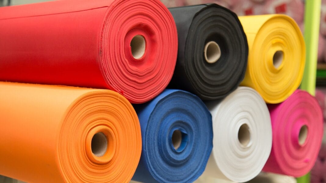 Different swimwear fabric rolls in vibrant colors