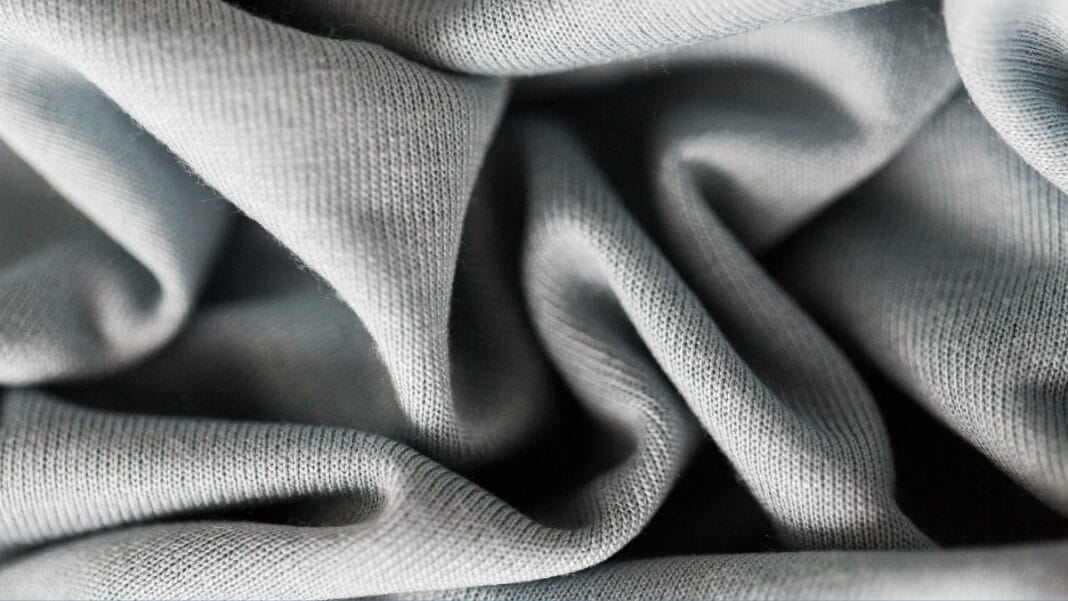 Light Grey Two-Way Stretch Fabric - Flexible and Comfortable Light grey two-way stretch fabric close-up showing its smooth texture and flexibility