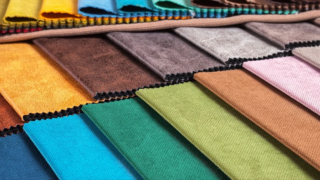  A selection of colorful upholstery fabric samples in various textures and hues