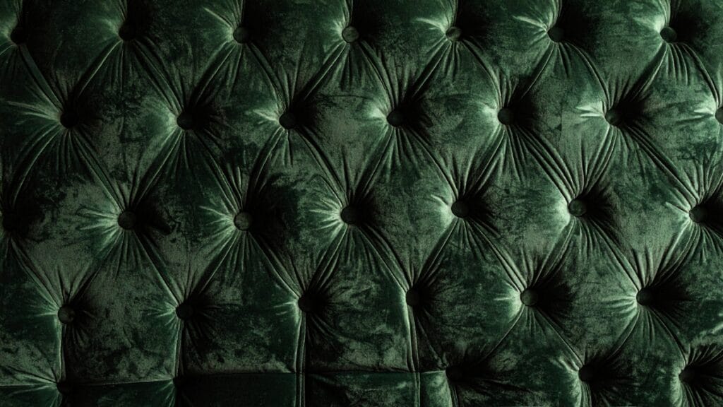 Green velvet upholstery fabric showcasing luxurious tufted texture